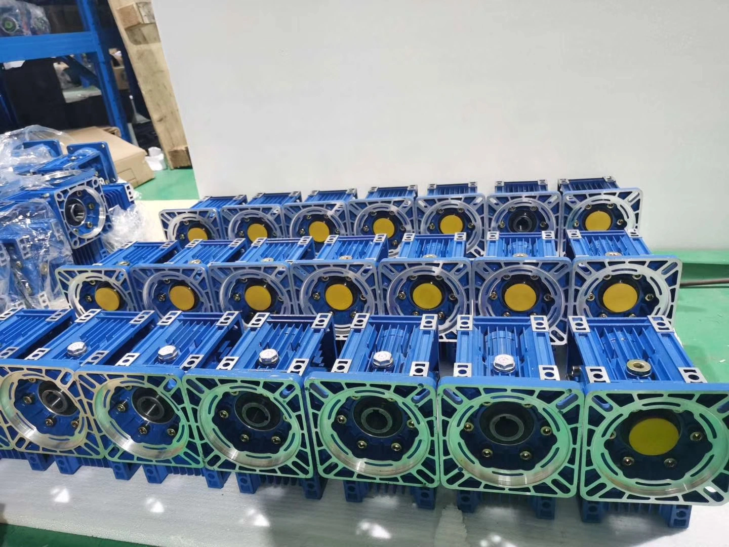 Group of blue worm gear reducers, finished reduction gearbox workshop production photo for cement industry Group of blue worm gear reducers, finished reduction gearbox workshop production photo for cement industry