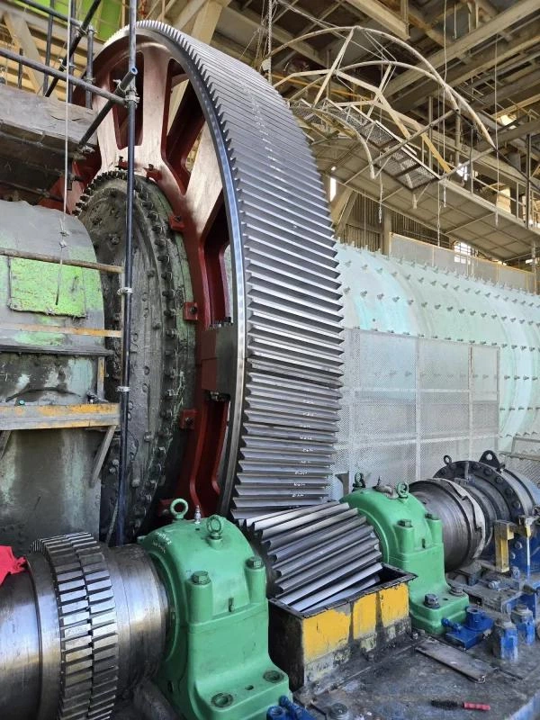 Ball mill girth gear and pinion meshing on cement plant working site, complete ball mill transmission assembly Ball mill girth gear and pinion meshing on cement plant working site, complete ball mill transmission assembly