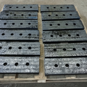 Vertical mill scraper blade, alloy wear plate with mounting holes, finished parts stacked on wooden pallet for cement vertical roller mill